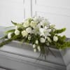 White floral casket spray with lilies and roses