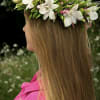 Girl wearing a white and green flower crown