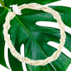 White flower lei on a large green leaf