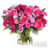 Overflowing with vibrant shades of pink, this charming arrangement features lush roses