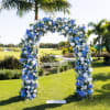 Blue and white floral arch on a lawn outdoors