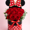 Red roses in a black round box with a Minnie Mouse bow topper