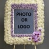 Rose-covered square easel display with a photo or logo center and orchids at the lower right
