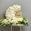 A serene and elegant sympathy arrangement designed to honor a life with
