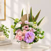 Pink and lavender floral arrangement in a polka-dot vase