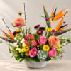 Colorful mixed flower arrangement in a white textured bowl vase