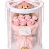 Pink rose bouquet in a clear gift box with a teddy bear and ribbon