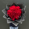 Large bouquet of red roses wrapped in black paper