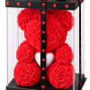 Red rose teddy bear in a clear display box with heart decorations