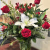 Bouquet of red roses and white lilies in a glass vase
