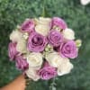 Bouquet of lavender and white roses held in hand
