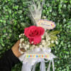 Pink rose bouquet with white baby's breath and birthday ribbons