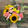 Bright yellow sunflowers steal the show in this cheerful mixed bouquet, paired