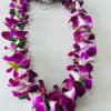 Purple orchid lei on a light background