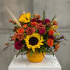 Sunflower and orange flower arrangement in a yellow vase