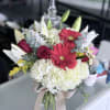 White Hydrangeas, red roses, red Gerber daisies, white Lillys. 