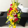 A bold, bright tribute, this rainbow of blooms fills the room with