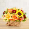 Basket arrangement with sunflowers, roses, lilies, and red daisies