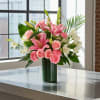 Pink lilies, roses, and carnations in a green vase