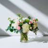 A delicate blend of light pink and soft white blooms, and lush