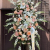 A tall, graceful standing spray that offers a gentle, refined tribute -