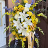 This tall spray combines lilies, roses, chrysanthemums, snapdragons, daisies, alstroemeria and seasonal