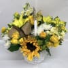 A bright sunflower anchors this cheerful flower arrangement, making it the perfect
