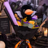 Halloween bouquet with a plush black bat and orange roses in black wrapping