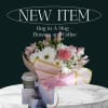 Bouquet of pink and white flowers with a coffee cup and gift items