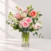 Pink and white flower arrangement in a clear glass vase