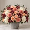 Peach roses, burgundy orchids, and white hydrangeas in a gray vase