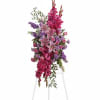Tall pink and purple floral arrangement on a white stand