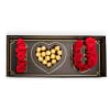 Heart-shaped chocolate box with red roses arranged around it