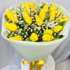 Yellow tulips with white baby's breath in pale wrapping