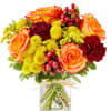 Bouquet of orange roses, red carnations, and yellow mums in a glass vase