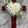 Cross-shaped floral arrangement with red and white roses