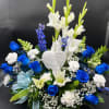 Blue and white floral sympathy arrangement with a memorial heart ornament