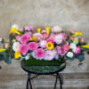 Premium Roses, Lisianthus, Calla Lilies, Ranunculus, and more in long rectangular vase.