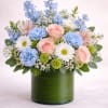  Description: A refreshing and elegant arrangement featuring soft blush roses, delicate