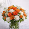 A radiant blend of vibrant orange roses, soft white carnations, delicate alstroemeria