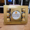 Box of Ferrero Rocher chocolates on a wooden table