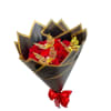 Red rose bouquet wrapped in black and gold paper with a red bow