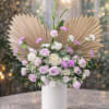 A soft and sophisticated arrangement featuring premium lavender and ivory roses, delicate