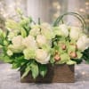  sophisticated blend of white roses, elegant lilies, green cymbidium orchids, and