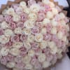 Large bouquet of pale pink and white roses wrapped in brown paper