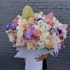 Large pastel flower arrangement in a white hat box