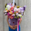 Large bouquet of multicolored roses and lisianthus with ribbon streamers