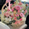 Pink and white flower basket with a ribbon handle