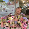 Large basket arrangement of pink and cream roses with lavender flowers