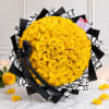 Large bouquet of yellow roses wrapped in black and white paper with a black ribbon